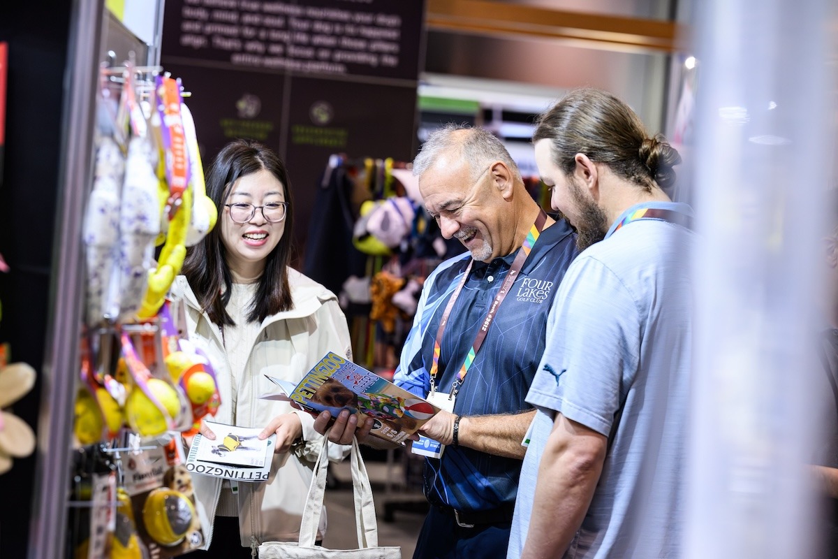 Pet Retail Buyers Browsing a Product Catalog and Smiling